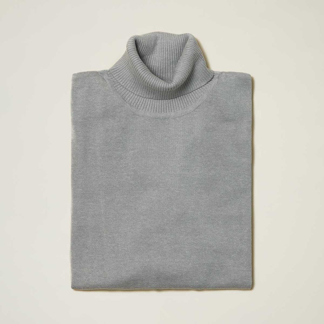 The Inserch Cotton Blend Slim Fit Turtleneck Sweater in gray (style 4808) by Inserch is shown neatly folded on a plain off-white background.
