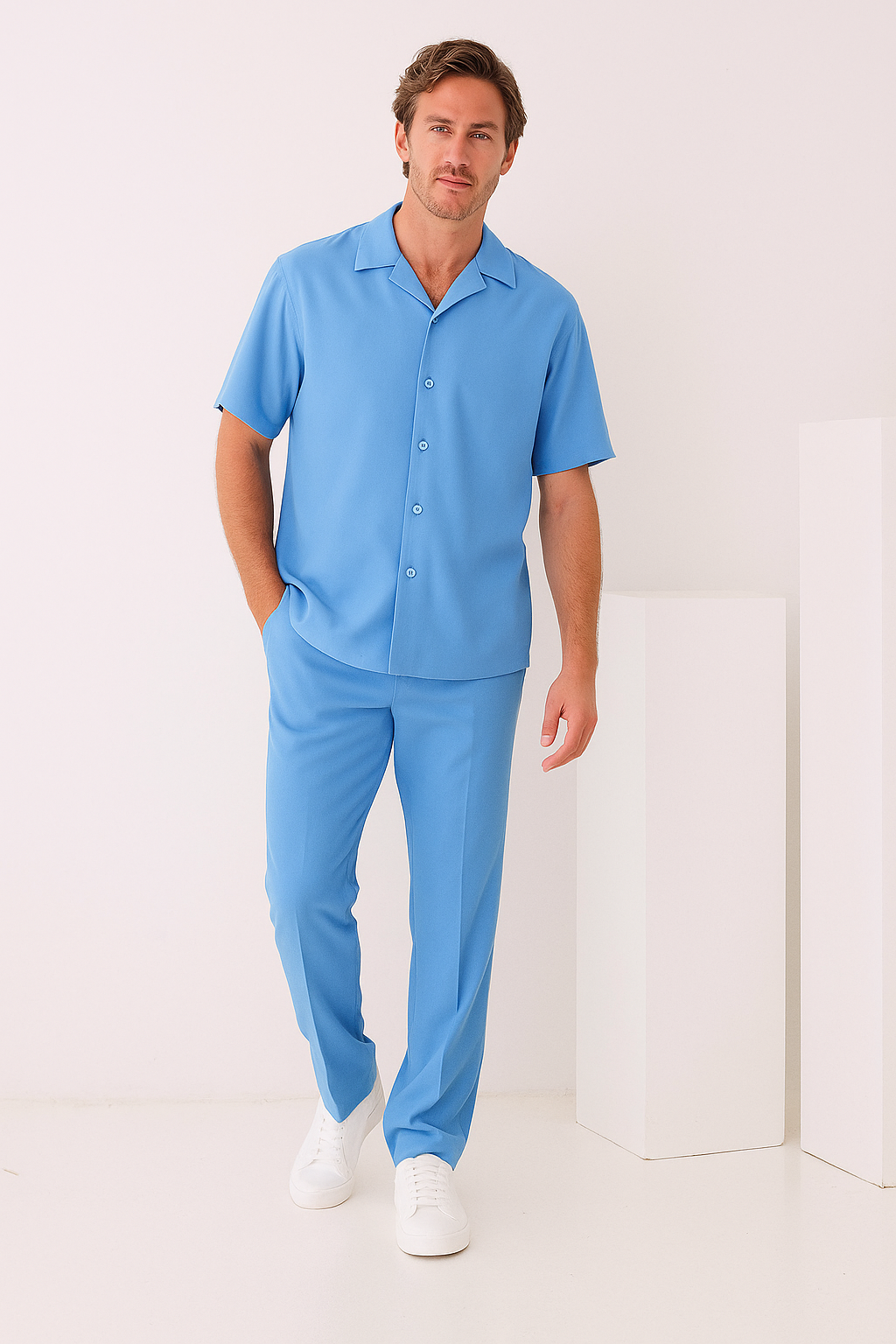 A close-up of the Inserch 2pc Set (Shirts and Pants) in Blue Mist by Inserch, highlighting the smooth high twist polyester fabric draped over a beige surface with its texture and precise edge on display.