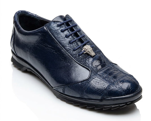 A single shoe from the Los Altos ZEUS Navy Ostrich Leg collection boasts a shiny, textured finish made from luxurious ostrich leg leather in dark blue, complete with decorative lacing and a small metallic emblem on top.