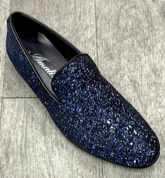 A single Exclusive Formal Dress Shoe Purple BARNES from UNIQUE DESIGN MENSWEAR, with its sparkly purple finish and genuine leather craftsmanship, rests elegantly on a light wooden floor.