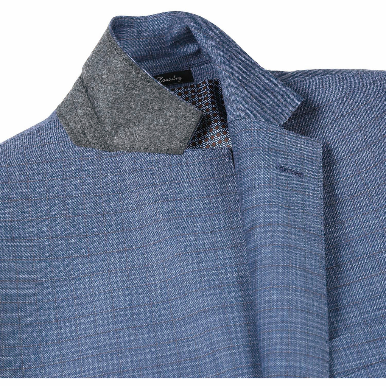 The ENGLISH LAUNDRY Pale Blue Wool Suit EL82-60-402, featuring a slim fit with a subtle check pattern and stylish notch lapels, pairs perfectly with a crisp white dress shirt and an orange patterned tie, elegantly displayed on a mannequin.