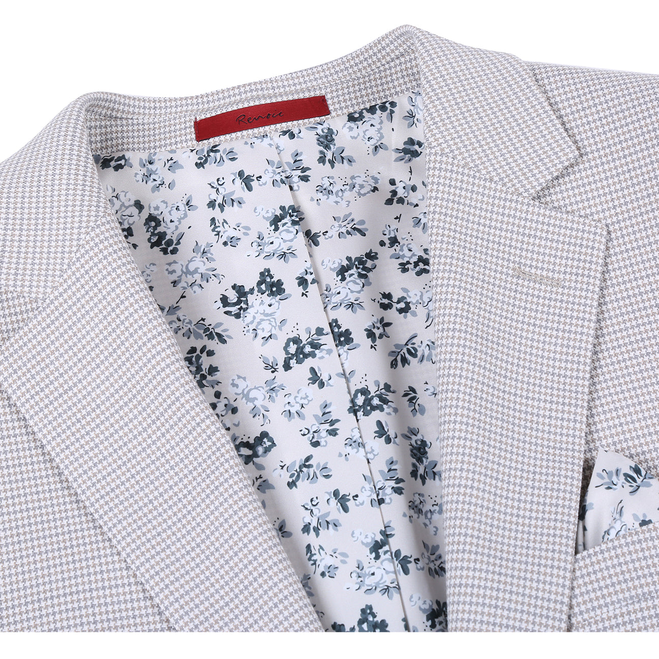 The Alessandro Vitello by Renoir Classic Fit Bib Light Beige Blazer 294-66 is displayed with a white dress shirt, dark patterned tie, and pocket square. This Renoir blazer features a notch lapel, two-button closure, and classic fit style.