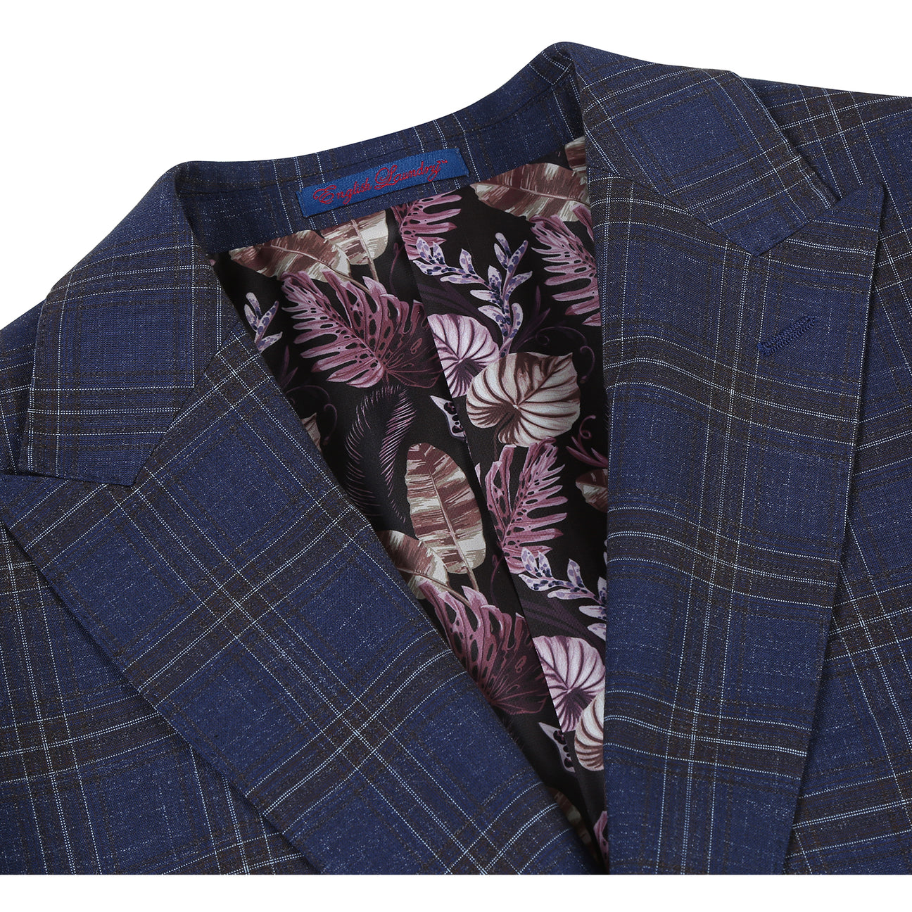 The ENGLISH LAUNDRY TR Suit 12-52-410EL by English Laundry is a slim fit blue plaid jacket with notch lapels, two buttons, and flap pockets, styled over a white dress shirt and red patterned tie on a display mannequin.