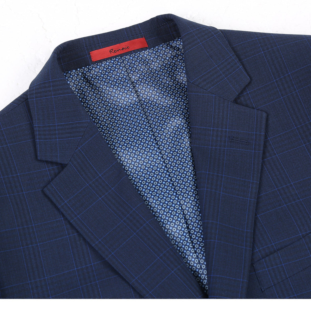 The Alessandro Vitello by Renoir Classic Fit Checked Suit in Marine Blue, styled on a mannequin with a white dress shirt and blue striped tie.