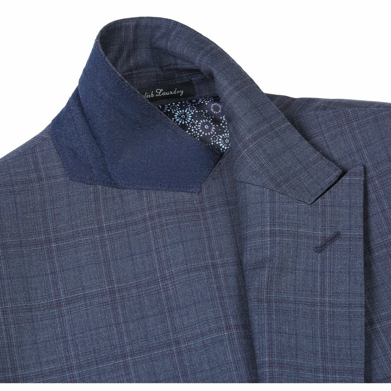 A mannequin is dressed in the English Laundry Gray Wool Suit EL82-66-095, a dark plaid wool suit jacket by English Laundry with a two-button closure, paired with a white dress shirt and a patterned orange tie.