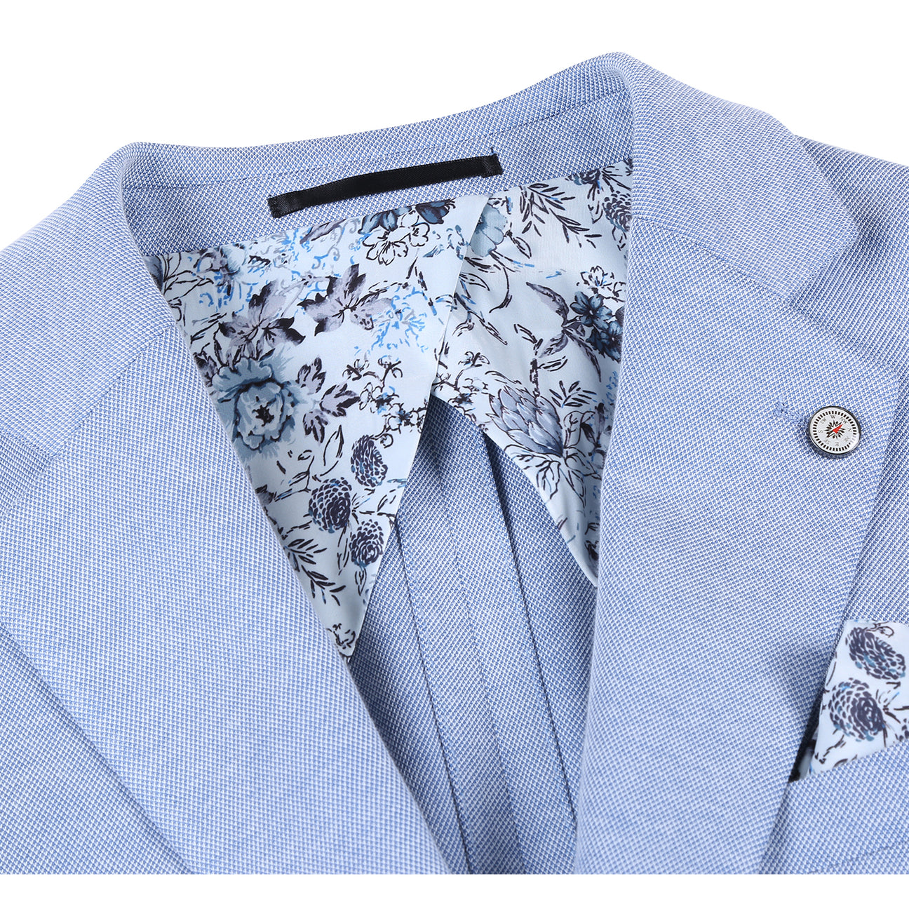 The Pellagio Light Blue Men's Slim Fit Riserva Jacket PS26-4 is shown on a mannequin, styled with a white shirt, multicolored plaid tie, and patterned pocket square for a modern Pellagio look.