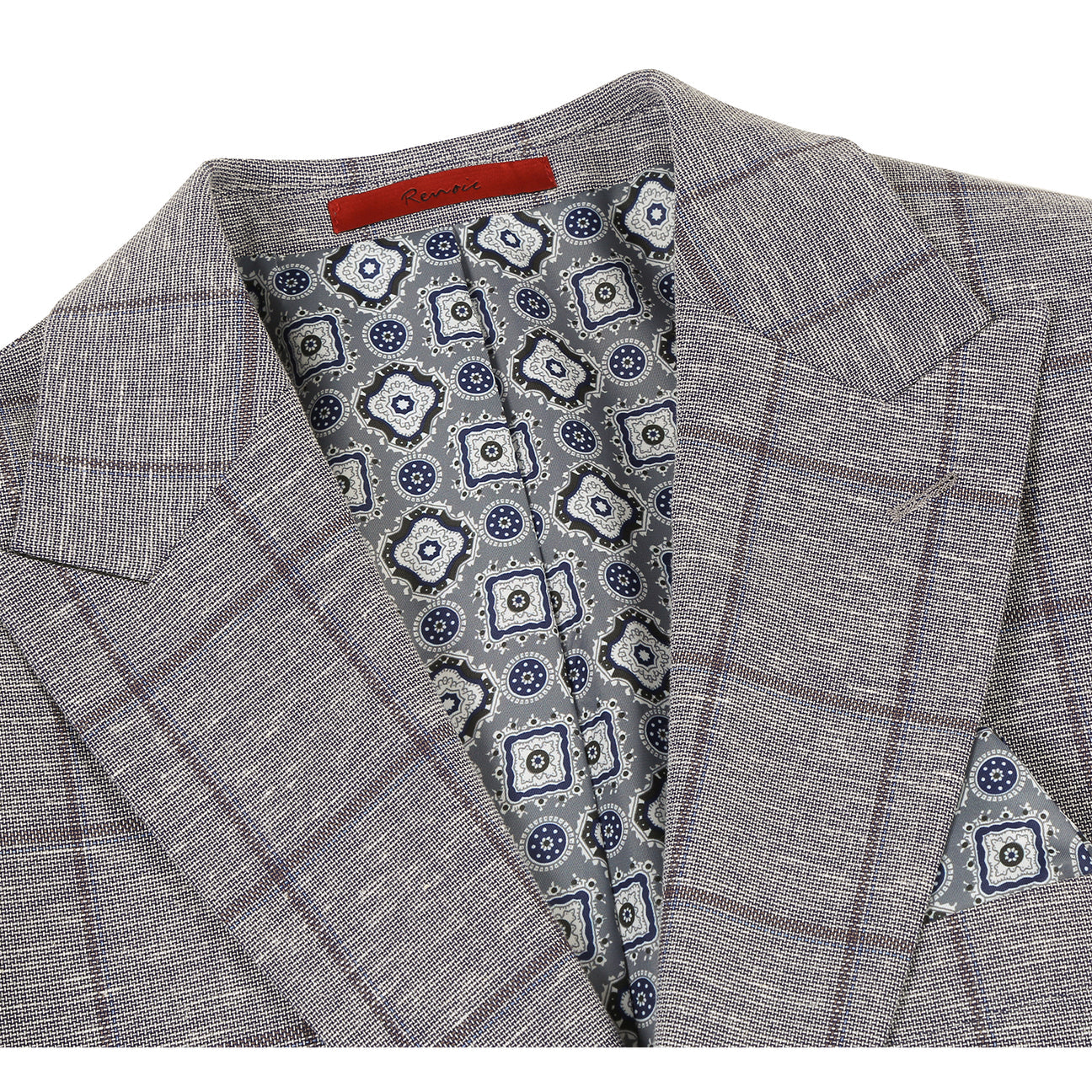 The Alessandro Vitello by Renoir Gray Blue blazer is styled on a mannequin with a white shirt, blue patterned silk tie, and matching pocket square.