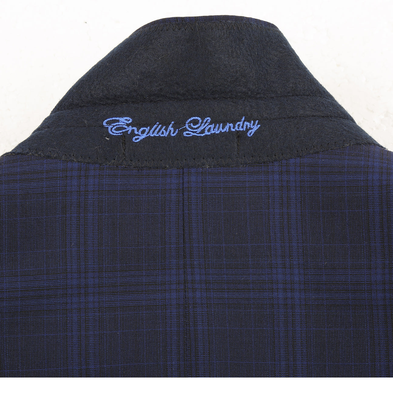 The ENGLISH LAUNDRY Dark Blue Wool Suit EL92-58-555 by English Laundry is a slim fit, plaid wool blazer with two buttons, notch lapels, flap pockets, and a patterned inner lining, shown against a white background.