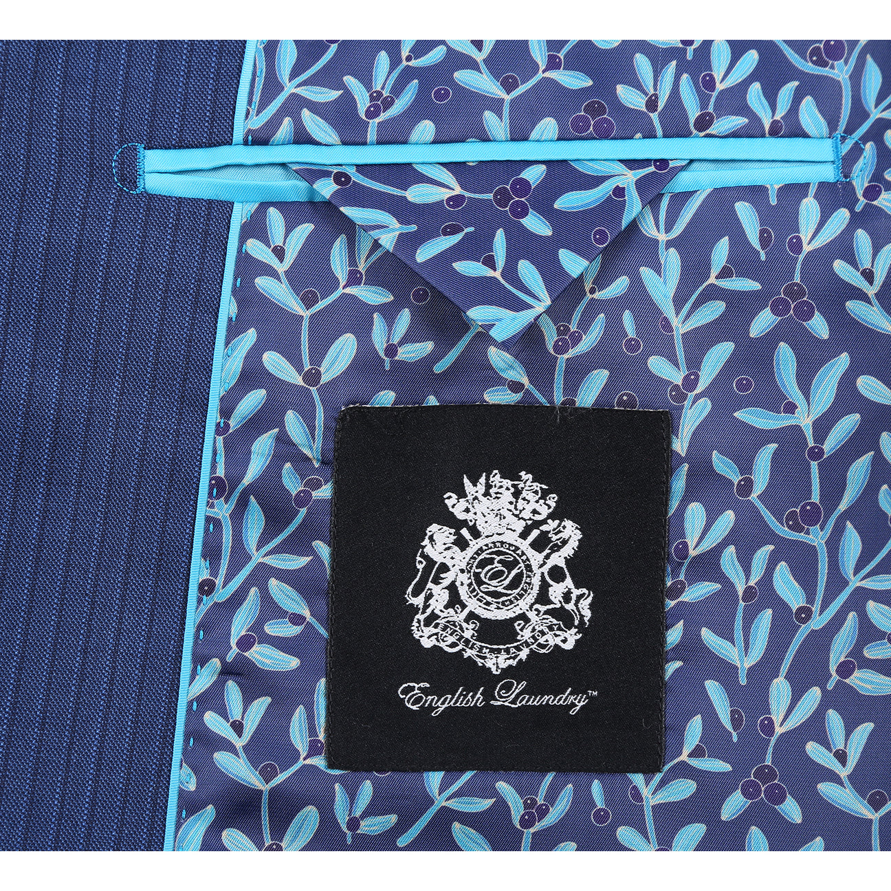 The English Laundry ENGLISH LAUNDRY 2pc Wool Suit Navy EL22-33-411 is a slim fit men's two-button jacket with blue pinstripes, side pockets, and a patterned inner lining, shown on a white background.