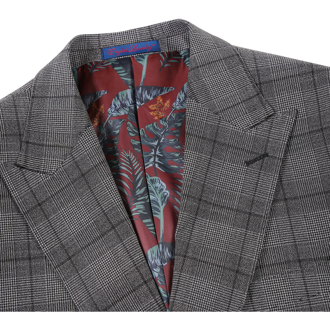 The ENGLISH LAUNDRY Gray Check Suit 22-60-002EL by English Laundry is displayed on a mannequin with a two-button closure, paired with a white dress shirt and a subtly patterned blue tie.