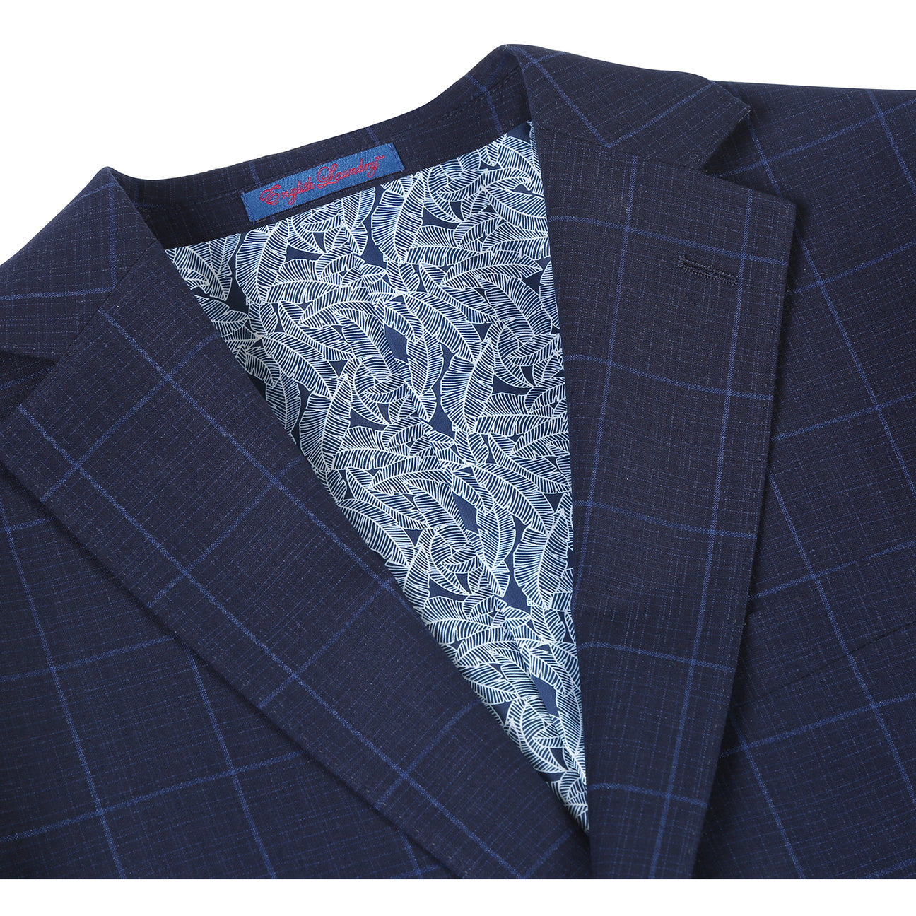 The ENGLISH LAUNDRY Midnight Blue Check Suit 12-55-410EL by English Laundry, featuring a slim fit jacket with notch lapels, is paired with a white dress shirt and red patterned tie on display.
