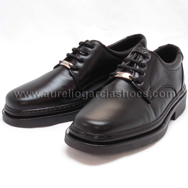 The P-5054 Belka Black Lace up by Pinoso's, part of the Men’s Shoes collection and made in Spain, is a black Nappa leather dress shoe with laces and a metal tag near the eyelets, displayed on a white background.