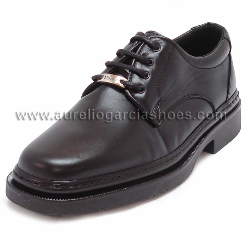 The P-5054 Belka Black Lace up by Pinoso's, part of the Men’s Shoes collection and made in Spain, is a black Nappa leather dress shoe with laces and a metal tag near the eyelets, displayed on a white background.