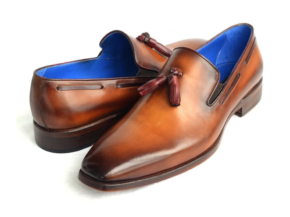 The Paul Parkman Tassel Loafer Walnut Leather Shoes (5141-WALNUT) feature Italian calfskin with a gradient brown finish, blue inner lining, and classic tassels. Displayed against a white background.