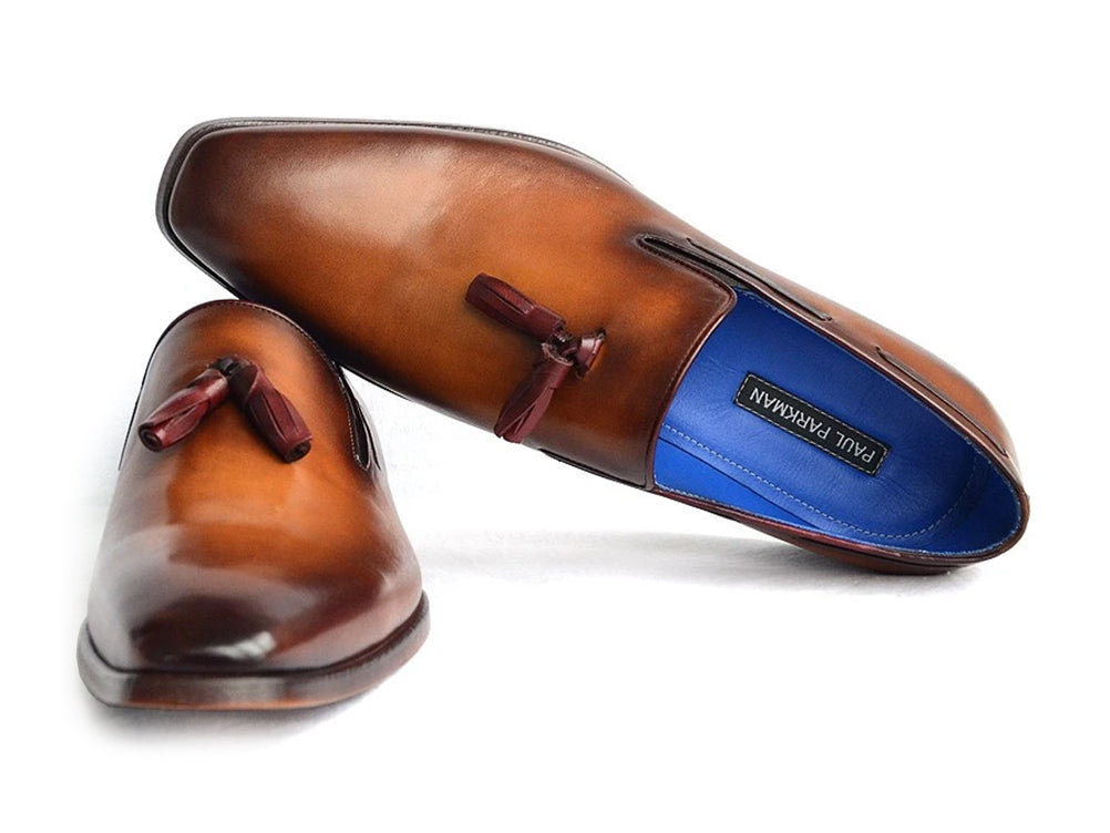 The Paul Parkman Tassel Loafer Walnut Leather Shoes (5141-WALNUT) feature Italian calfskin with a gradient brown finish, blue inner lining, and classic tassels. Displayed against a white background.