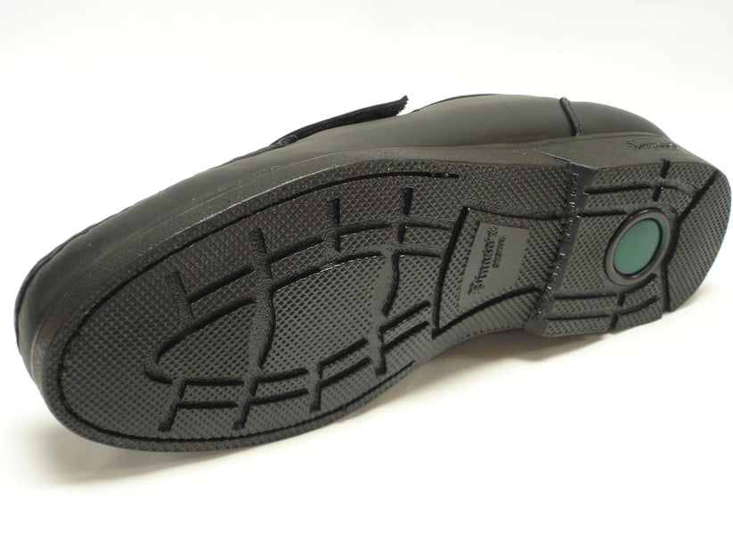 The Pinoso's P-5203-628 Black Leather Velcro Strap shoes for men, handcrafted in Spain, feature stitching details and rubber soles for comfort, shown on a white background.