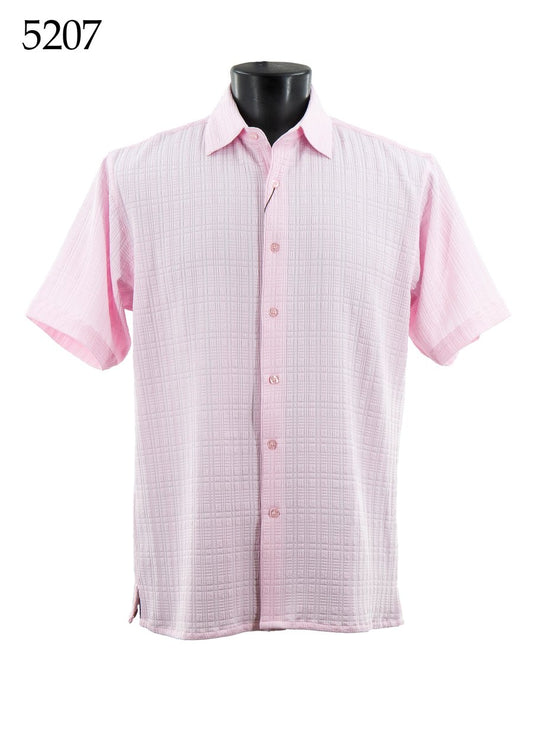 The Bassiri Short Sleeve Shirt 5207 is a light pink, regular fit, short-sleeved button-up shirt with a subtle checkered pattern, showcased on a black mannequin. The number 5207 appears in the top left corner. Brand: Bassiri.