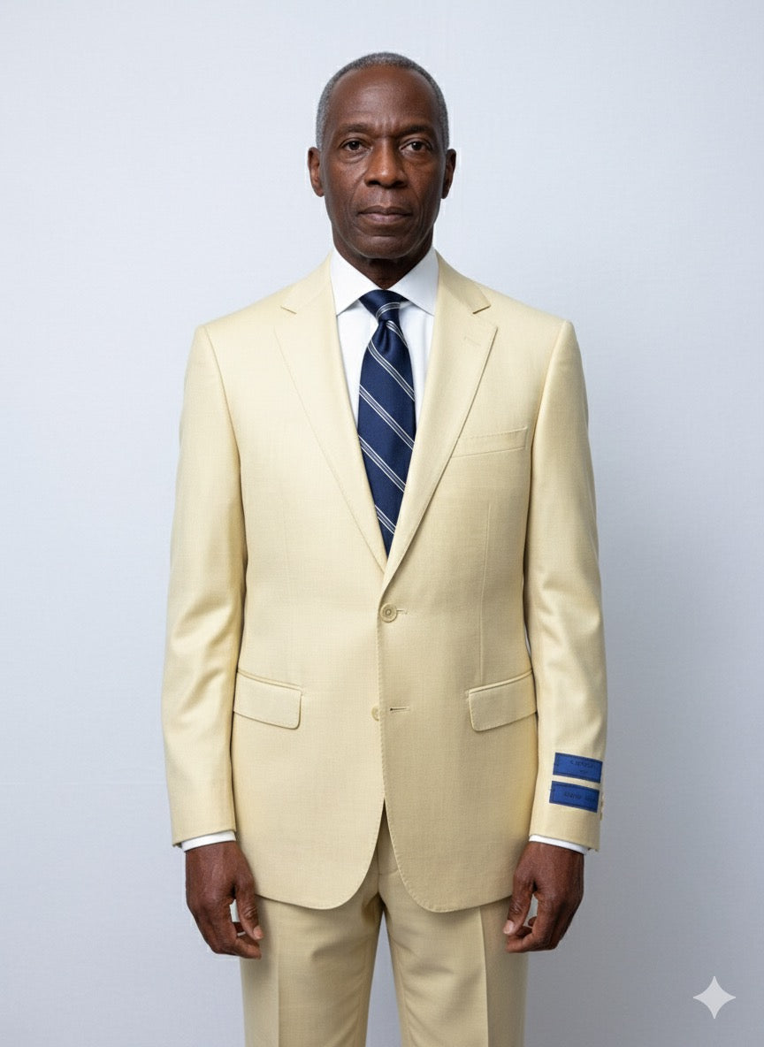The Cavelli Uomo Porto SLIM FIT Suit 1986/21 in light yellow by CAVELLI features a slim fit, lapel, two front pockets, and blue sleeve tag. Displayed on a hanger against a wooden floor. FINAL SALE: NO RETURN OR EXCHANGE.