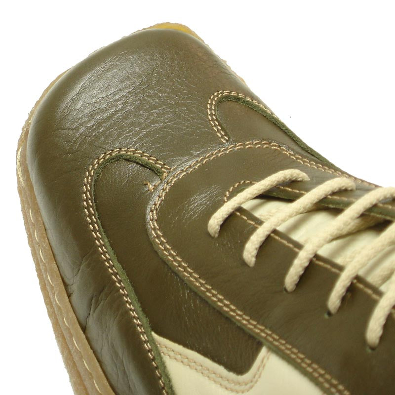 The Pinoso's P-5456 Javier Beige Green Leather Lace-up Sneaker, made in Spain, features textured tan rubber soles and blends European style with olive green and beige leather against a crisp white background.