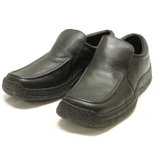 The Pinoso's P-5456 Javier Black Leather Slip-on Loafer for men features nappa leather and textured rubber soles, shown against a white background. Made in Spain.