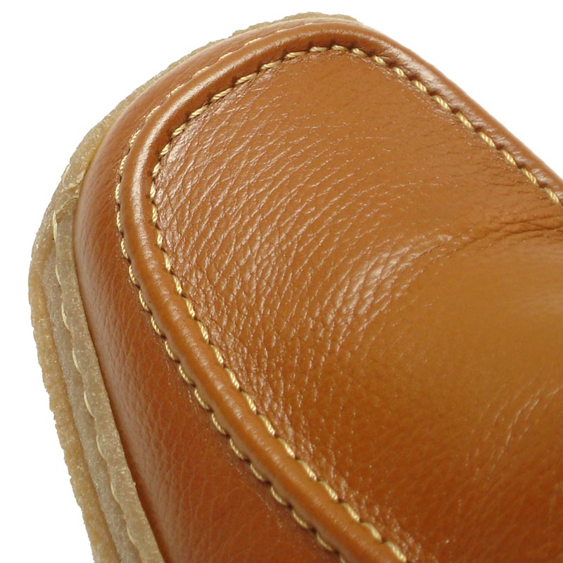 The Pinoso's P-5456 Javier Tan Leather Slip-on Loafer for men, made in Spain, features brown Nappa leather, visible stitching, and textured rubber soles, offering handcrafted comfort against a white background.