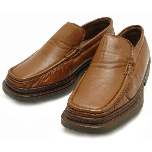 The P-5492 Goran Tan Leather Slip-on Loafer by Pinoso's, made in Spain, features a sleek design with square toes and stitched detailing along the upper edges.