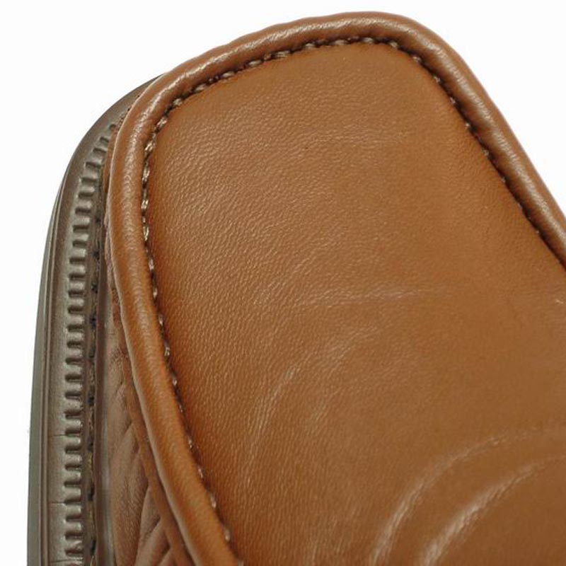 The P-5492 Goran Tan Leather Slip-on Loafer by Pinoso's, made in Spain, features a sleek design with square toes and stitched detailing along the upper edges.