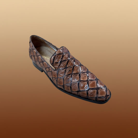 A single Belvedere Shoe 5 loafer in brown, featuring shiny textured leather with a diamond pattern, is displayed on a wooden surface. Brand: BELVEDERE. FINAL SALE—NO EXCHANGE, NO RETURN. Size 9 only.
