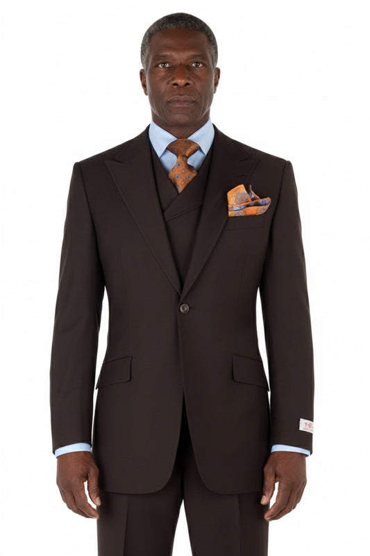 The Tiglio Rosso San Giovesse Brown TIG1003 three-piece suit, crafted from 100% wool, is paired with a light blue dress shirt, an orange patterned tie, and a matching pocket square.