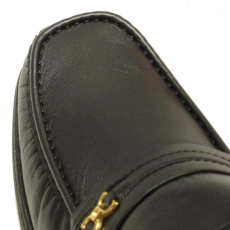 The Pinoso's P-5615-668 Black Leather Slip on Loafer for men is crafted in Spain from premium black leather, featuring a low heel and a decorative metal bit on the strap.