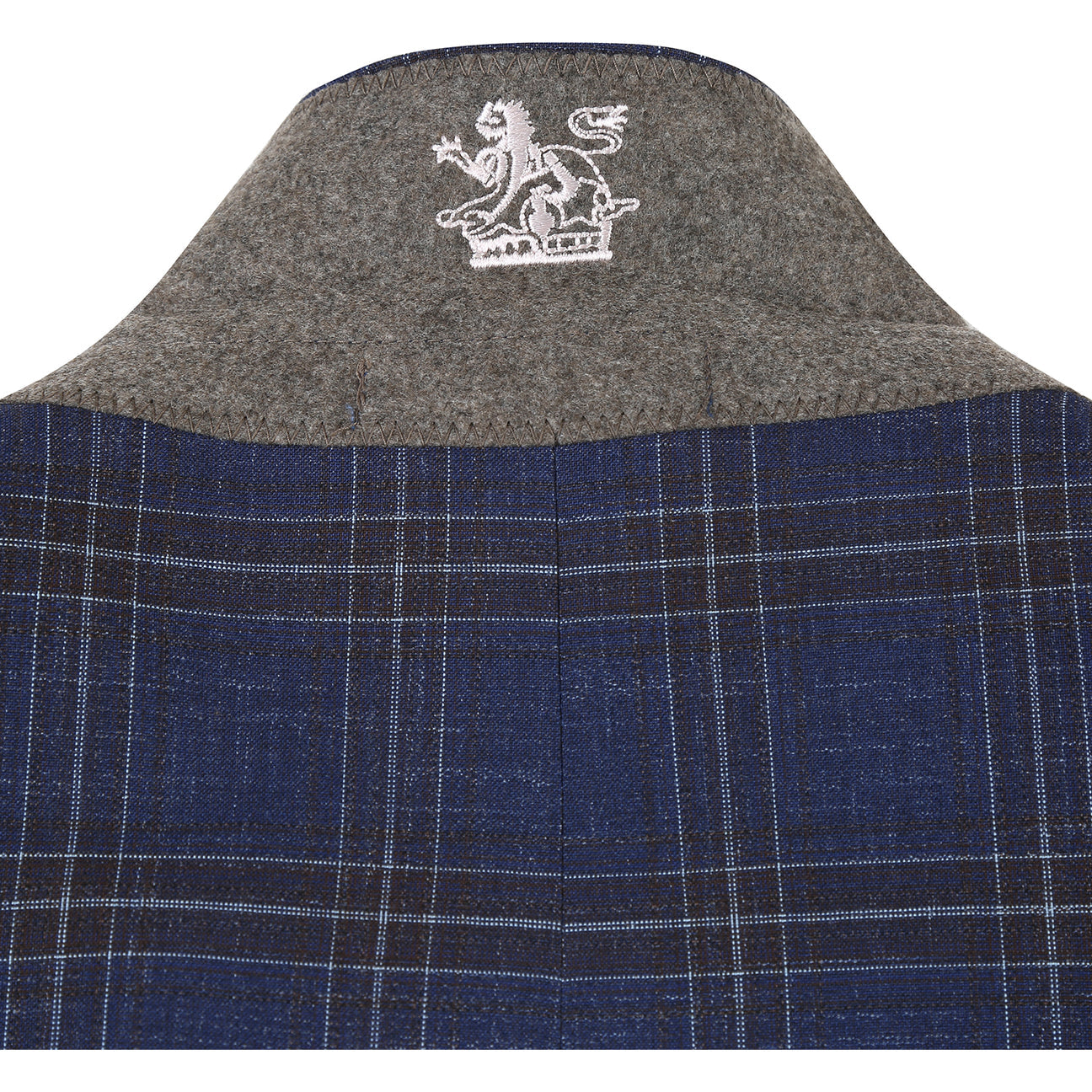 The ENGLISH LAUNDRY TR Suit 12-52-410EL by English Laundry is a slim fit blue plaid jacket with notch lapels, two buttons, and flap pockets, styled over a white dress shirt and red patterned tie on a display mannequin.