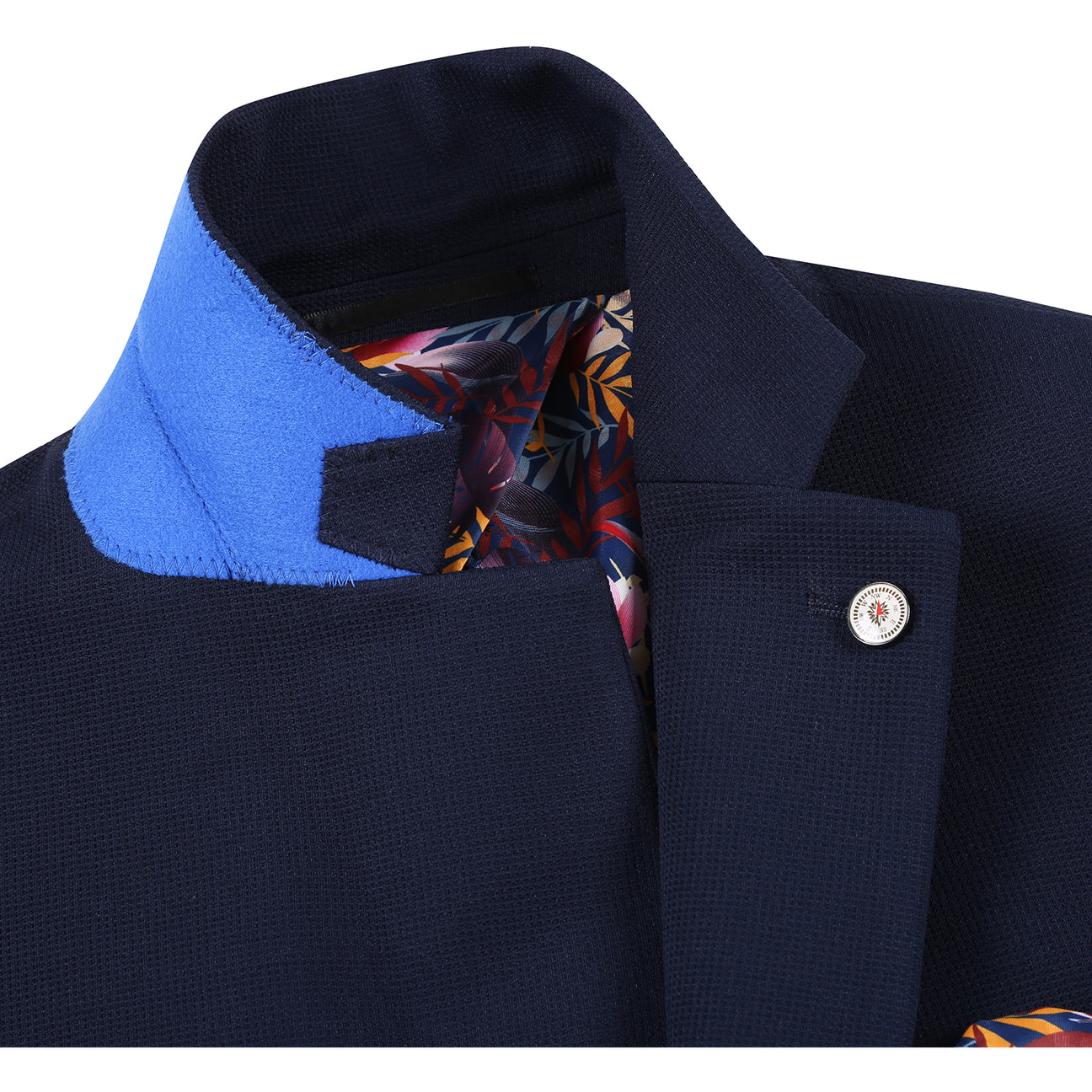 The Pellagio Men's Half Canvas Blazer Navy PS25-17, a single-breasted jacket with notched lapel and two buttons, is styled with a white dress shirt, patterned beige tie, and colorful pocket square on a display mannequin.