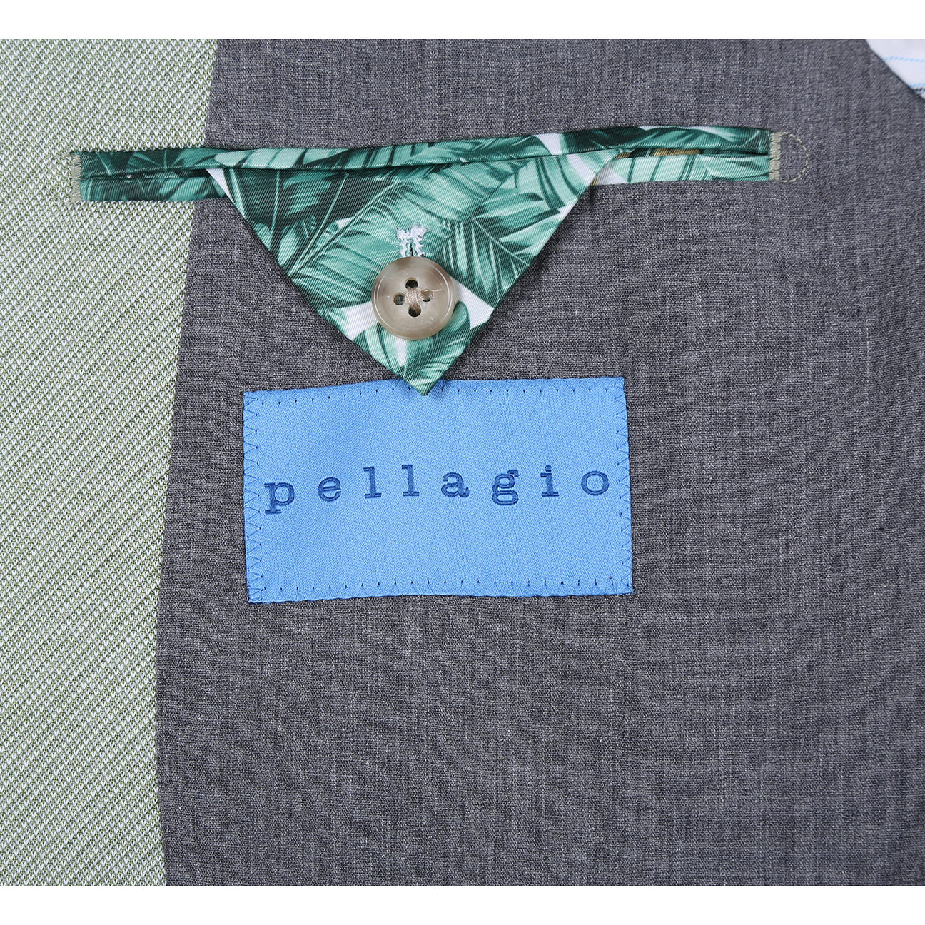 The Pellagio Light Green Men's Slim Fit Riserva Jacket PS26-3, styled on a mannequin with a white shirt, striped tie, and green pocket square, offers a sharp and modern look from the Pellagio brand.