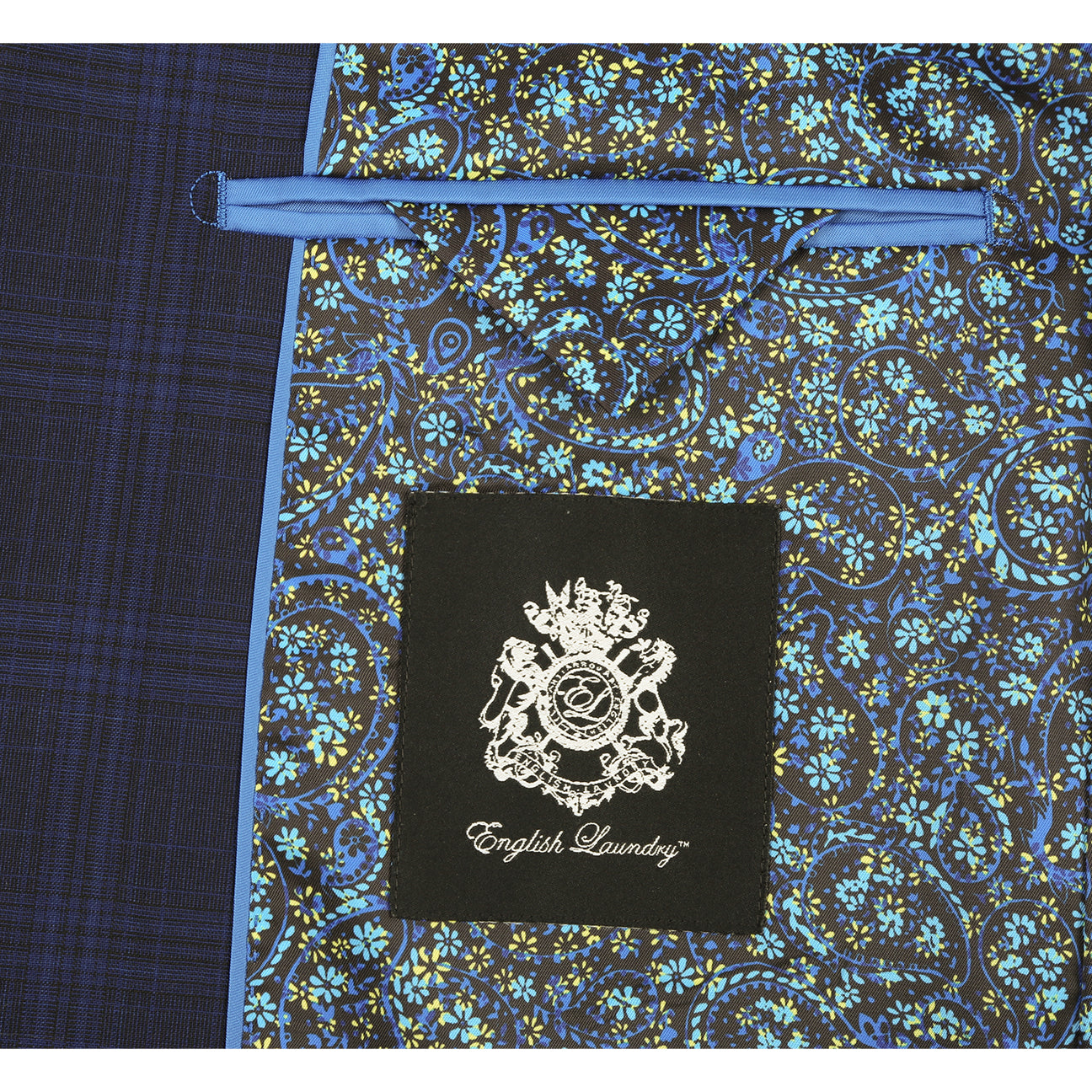 The ENGLISH LAUNDRY Dark Blue Wool Suit EL92-58-555 by English Laundry is a slim fit, plaid wool blazer with two buttons, notch lapels, flap pockets, and a patterned inner lining, shown against a white background.