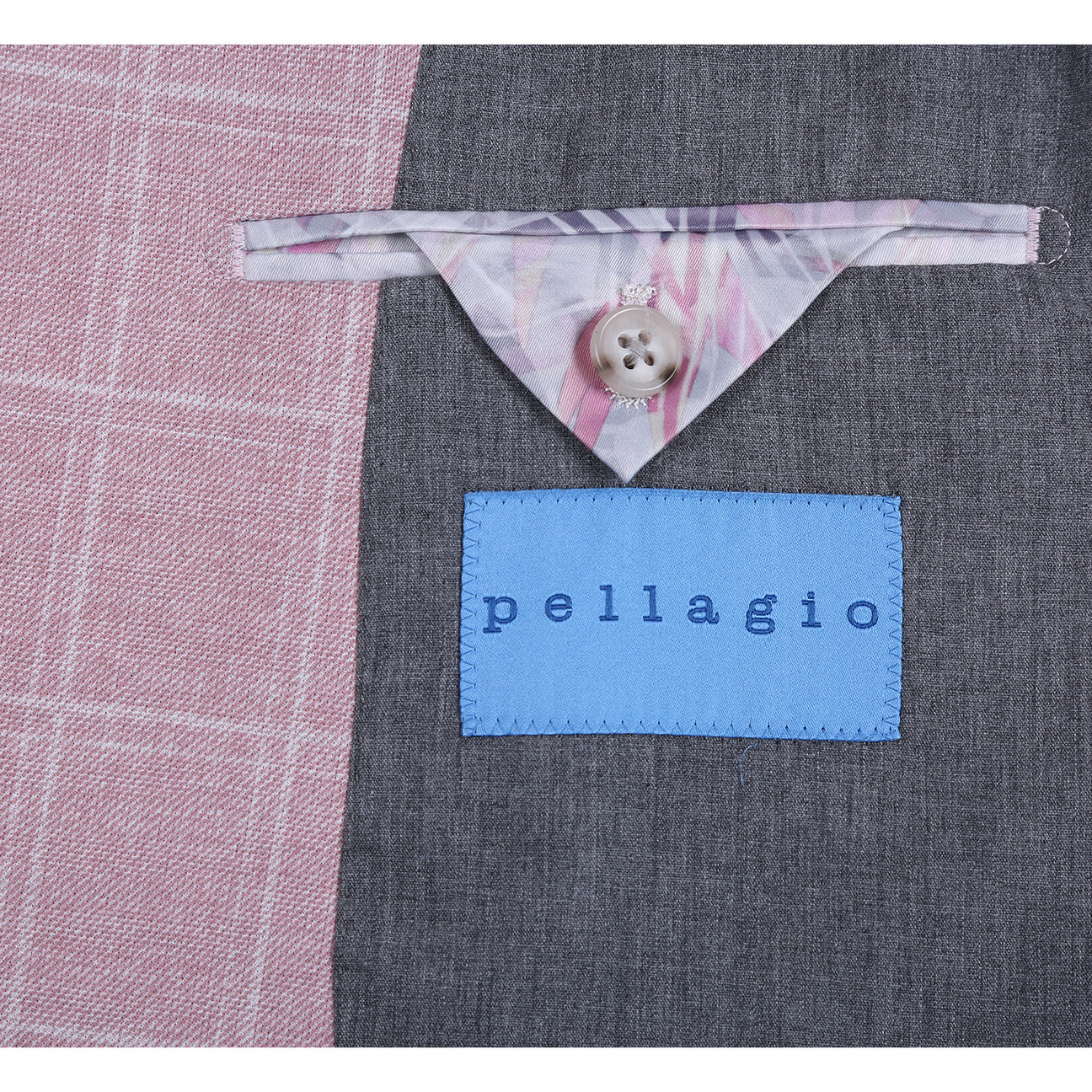 The Pellagio Pink Men's Slim Fit Riserva Jacket PS26-8 features notch lapels, two buttons, front pockets, and a matching pocket square. Shown on a mannequin with a white shirt and striped tie. Brand: Pellagio.