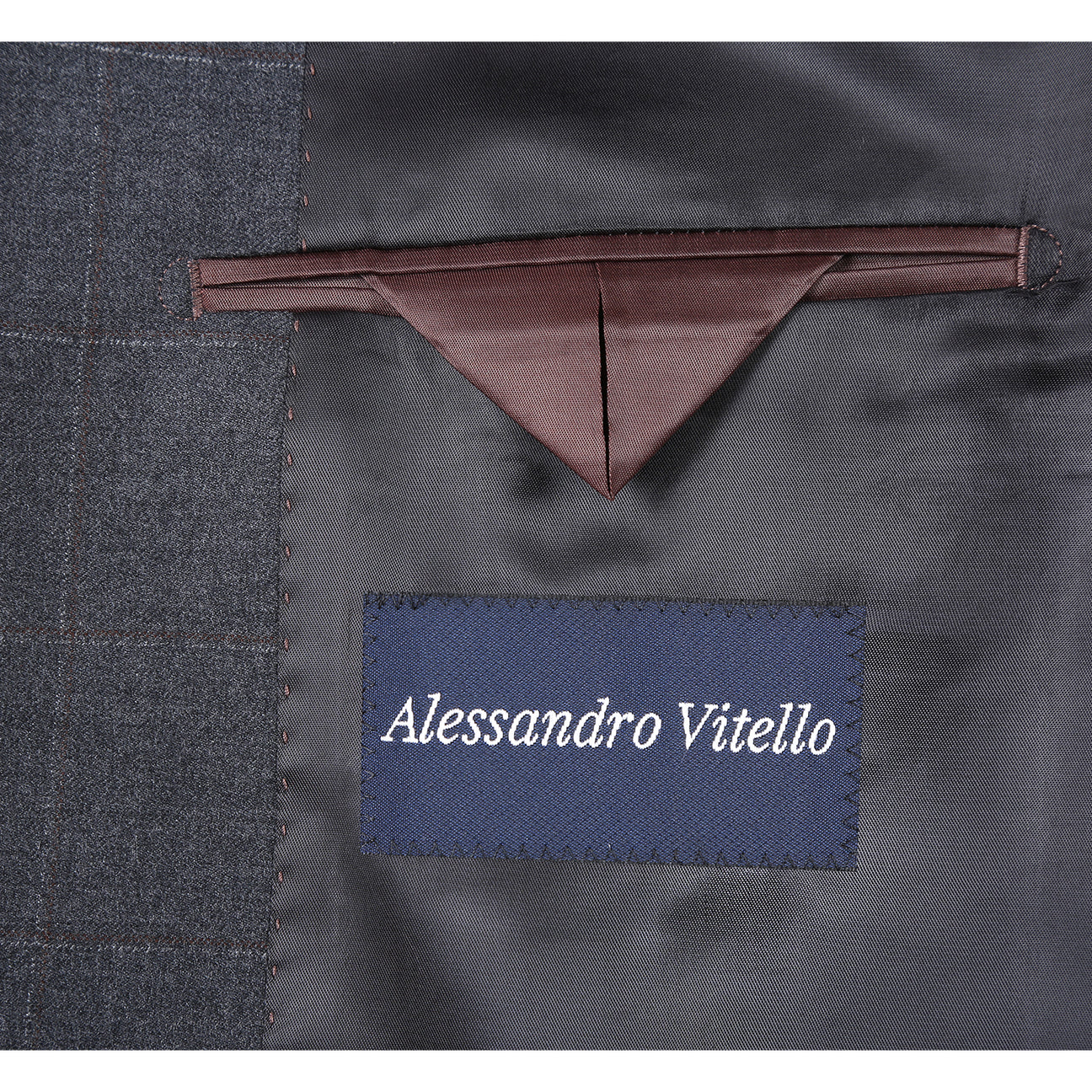 The Renoir Alessandro Vitello Classic Fit Wool Gray Suit 566-6 features a dark gray plaid jacket, paired with a white shirt and blue patterned tie, shown on a mannequin—ideal for those seeking a timeless men's single-breasted suit.