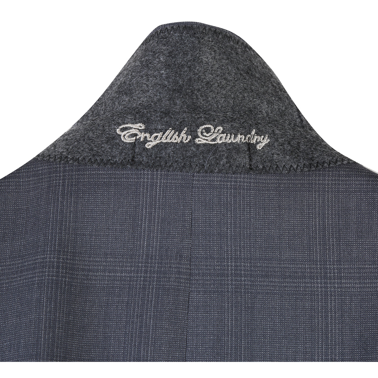The English Laundry Grey Wool Suit EL92-58-095 features a slim fit, notch lapels, two buttons, and flap pockets. Crafted from 90% wool, it's displayed over a white dress shirt and navy striped tie on a mannequin.