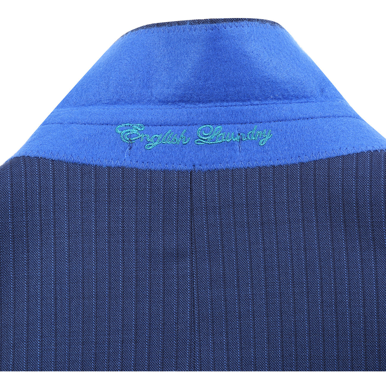The English Laundry ENGLISH LAUNDRY 2pc Wool Suit Navy EL22-33-411 is a slim fit men's two-button jacket with blue pinstripes, side pockets, and a patterned inner lining, shown on a white background.