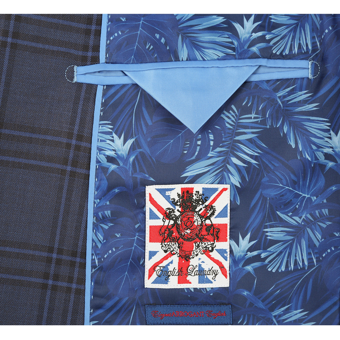 The ENGLISH LAUNDRY Grey Check Suit 12-53-093EL by English Laundry is a men's slim fit grey plaid blazer with two buttons, notched lapels, flap pockets, and a blue tropical-patterned inner lining.