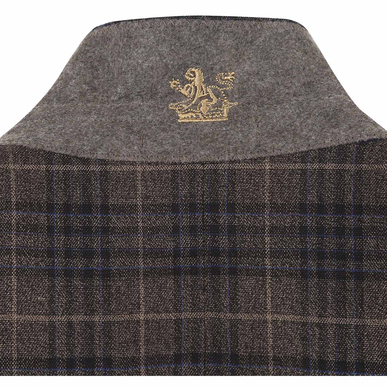 The mannequin is adorned in an English Laundry three-piece sand brown check suit, featuring a sleek jacket that drapes elegantly over a white dress shirt, complemented by a maroon polka dot tie.