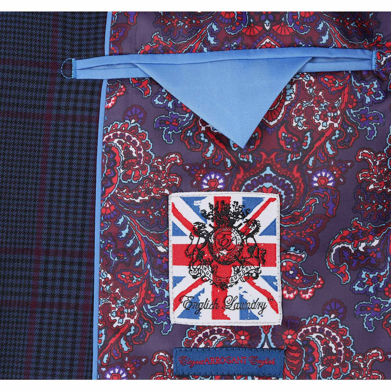 The mannequin displays an ENGLISH LAUNDRY Blue with Burgundy Check Suit, showcasing a slim fit and refined notch lapels. The ensemble is elegantly complemented by a crisp white shirt and a striking red tie, while the two-button closure provides a classic finish.