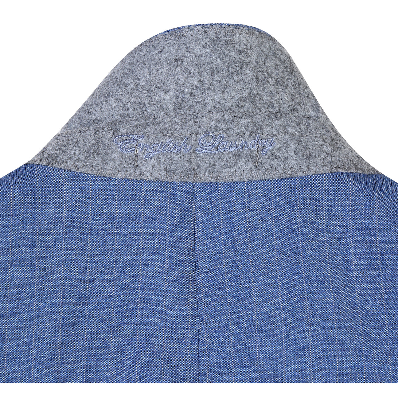 The ENGLISH LAUNDRY Light Blue Wool Suit EL92-33-412 by English Laundry features a slim fit, peak lapels, and pinstripes; displayed on a mannequin with a white dress shirt and blue patterned tie.