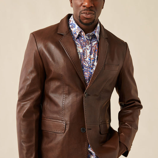 The Inserch Leather Blazer 600-104 Cognac by Inserch features a modern fit, notch lapels, two front buttons, three pockets, and visible pique stitch detailing, displayed flat on a light background.