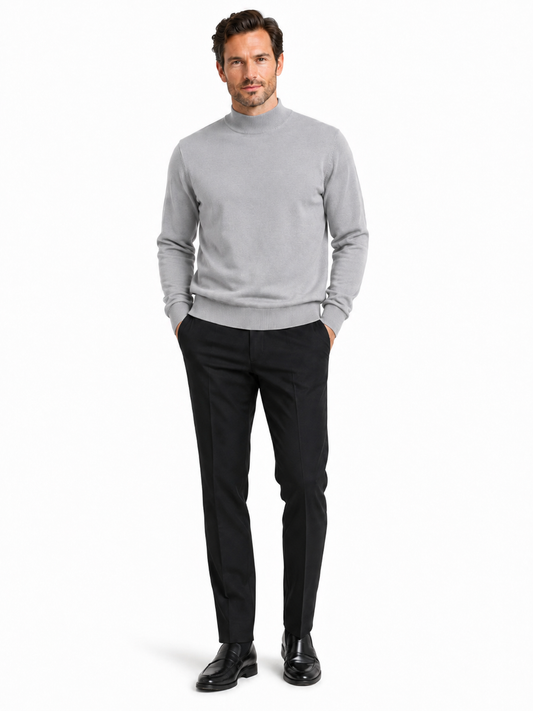 The Bassiri L/S Mock-Neck Silver Sweater 630 is a plain gray long-sleeve sweater made from soft cotton with a high collar, styled against a white background.