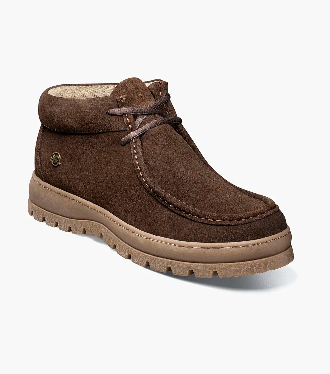 The Stacy Adams Dublin II Moc Toe Boot in brown features a suede upper, beige rubber lug sole, visible stitching, lace-up front, and a small round side logo.