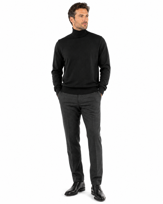 The Bassiri L/S Turtleneck Black Sweater 631 by Bassiri is an elegant black turtleneck sweater made from soft Tencel, beautifully showcased against a white background.