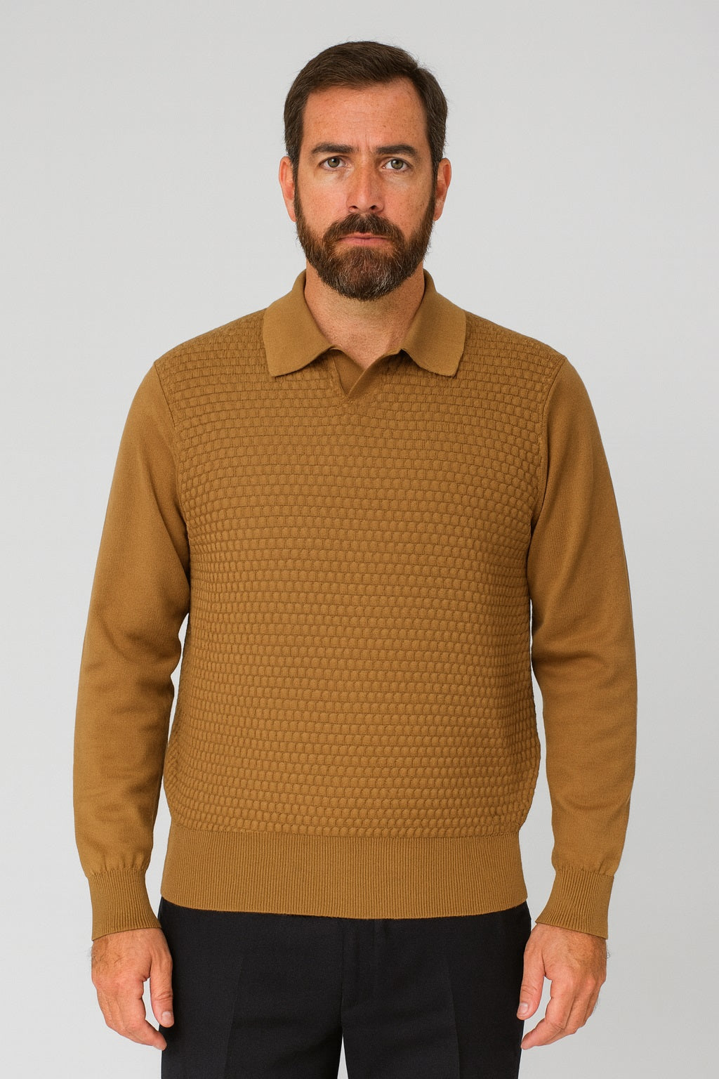 A man with a beard wears the Bassiri Long Sleeve Collar Neck Cognac Sweater 640 and black pants, standing facing the camera against a plain background.