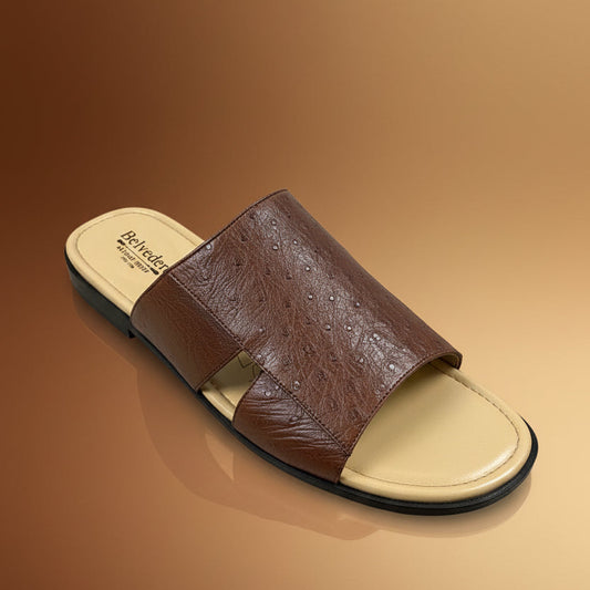 A BELVEDERE "Shoe 2" clearance slide sandal in brown leather, featuring a textured upper and a beige branded insole, sits on a light wood surface. Please note: this item is FINAL SALE (Size 9 Only) and not eligible for return or exchange.