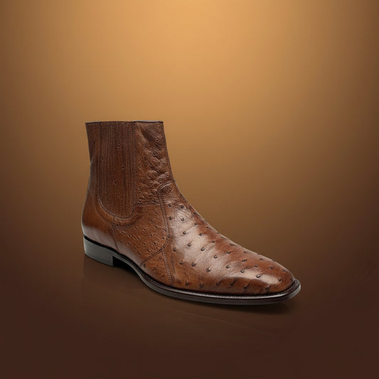 A single Belvedere Shoe 10 in brown ostrich leather (Size 9 only), featuring a square toe, is displayed on a wooden surface with folded clothes in the background. Please note, this BELVEDERE item is clearance and final sale—no exchange or return accepted.