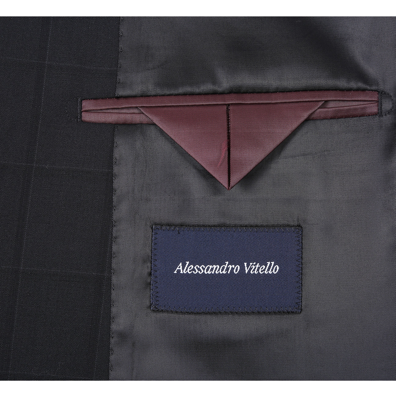 The Renoir Alessandro Vitello New Slim Fit Wool Black Suit 566-15 features a modern black checkered design, displayed on a mannequin with a white dress shirt and purple tie, blending classic style with contemporary fit.